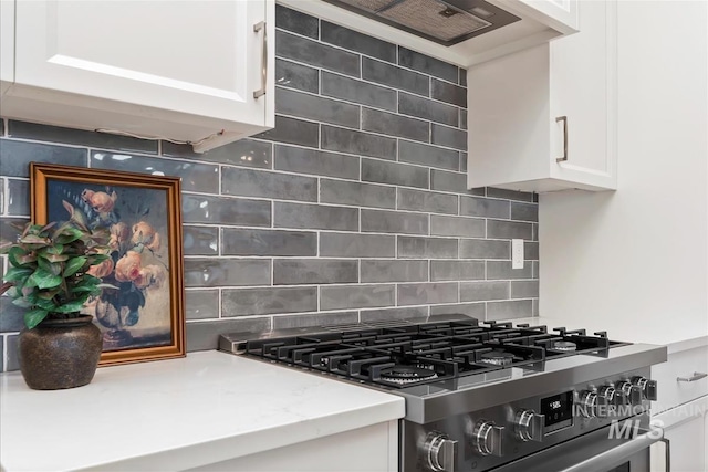 6874 N Fireball, Meridian, ID 83646 - kitchen view of stainless steel gas range, white cabinets, backsplash, and extractor fan