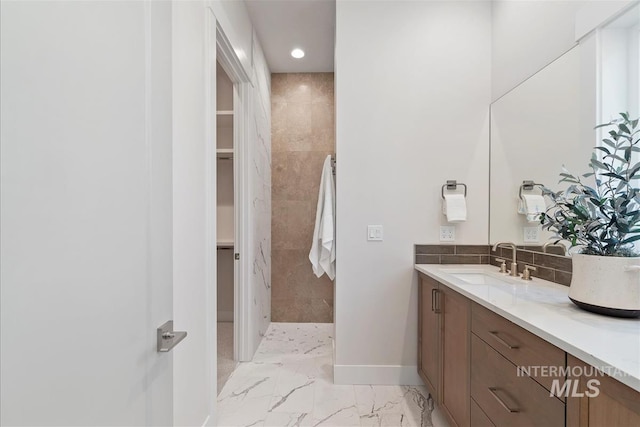 6874 N Fireball, Meridian, ID 83646 - full bathroom with marble finish flooring, vanity, a spacious closet, tiled shower, and baseboards