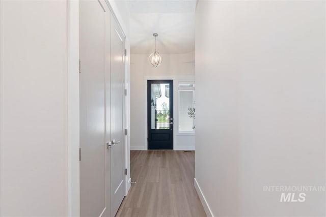 6874 N Fireball, Meridian, ID 83646 - hall featuring light wood-style flooring, baseboards, and a chandelier