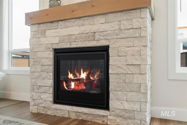 6874 N Fireball, Meridian, ID 83646 - detailed view of a fireplace, wood finished floors, and baseboards