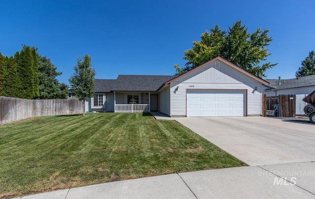 ranch-style house featuring a garage, a front yard, and covered porch