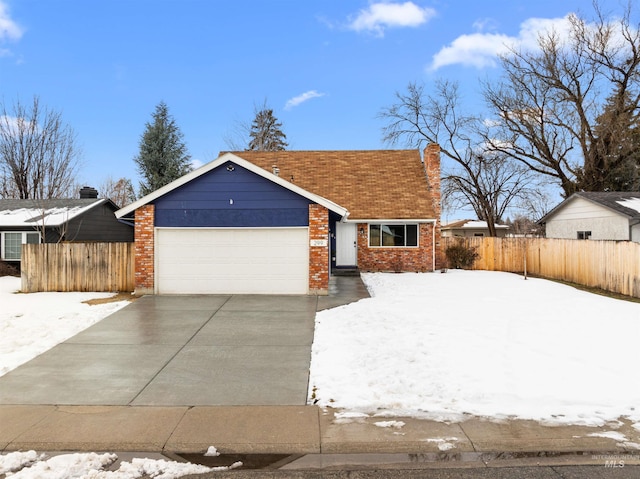 view of front of house featuring brick siding, a chimney, concrete driveway, an attached garage, and fence