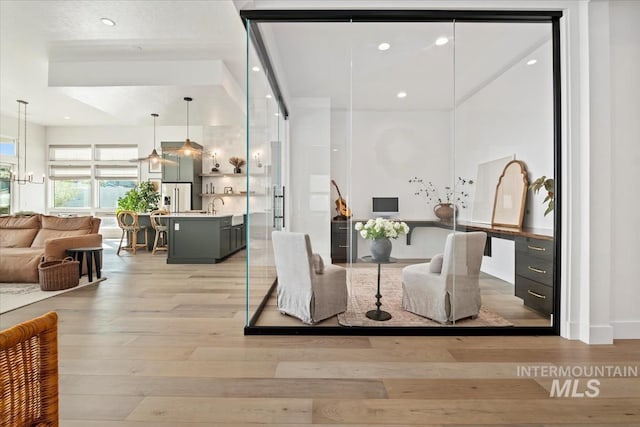 dining room with light wood finished floors and recessed lighting