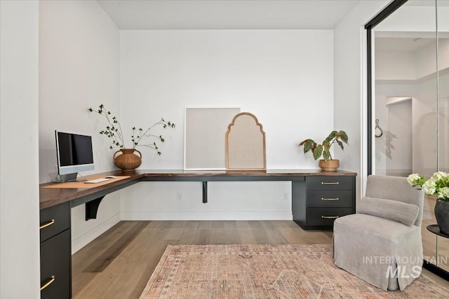 home office with wood finished floors