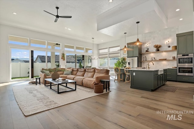 living room featuring ceiling fan, recessed lighting, and wood finished floors