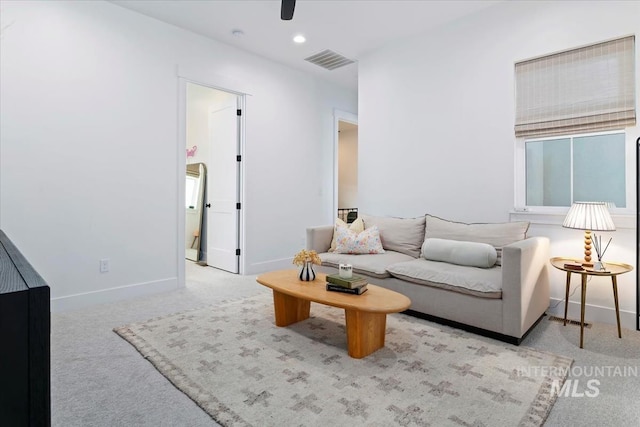 living area featuring carpet floors, baseboards, a ceiling fan, and recessed lighting
