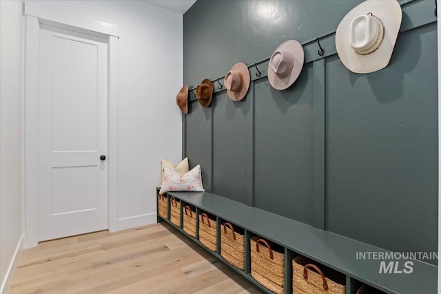 mudroom featuring baseboards and wood finished floors
