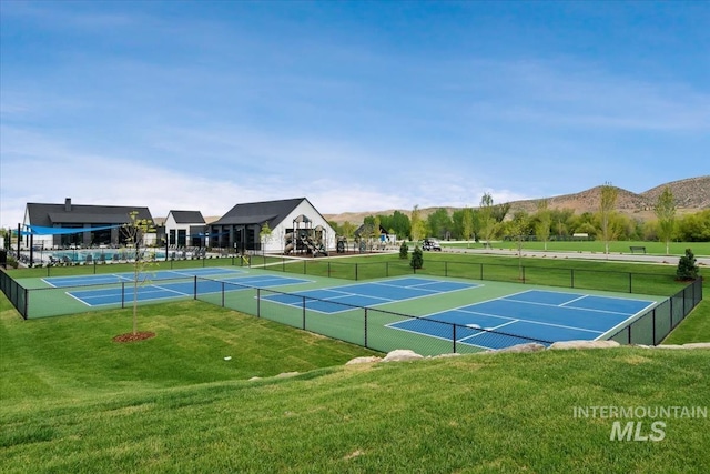 view of tennis court featuring a mountain view