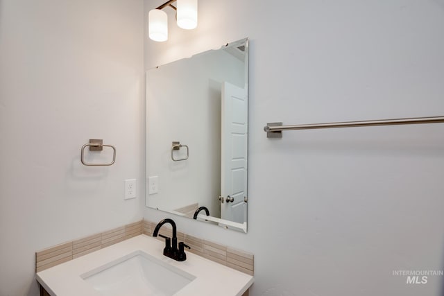 bathroom with vanity and decorative backsplash