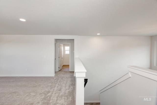 interior space with recessed lighting, light colored carpet, and baseboards