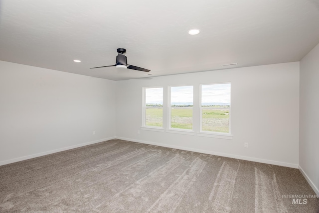 spare room featuring ceiling fan, recessed lighting, light colored carpet, and baseboards