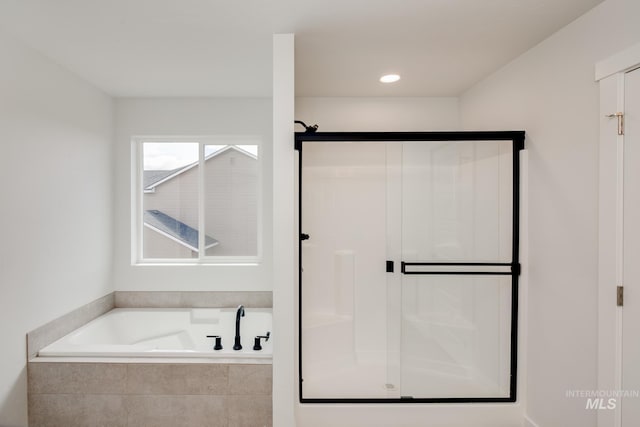 bathroom with a garden tub and a stall shower