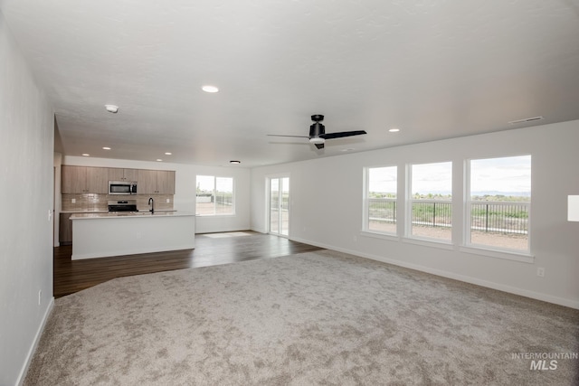 unfurnished living room with visible vents, baseboards, a ceiling fan, and recessed lighting