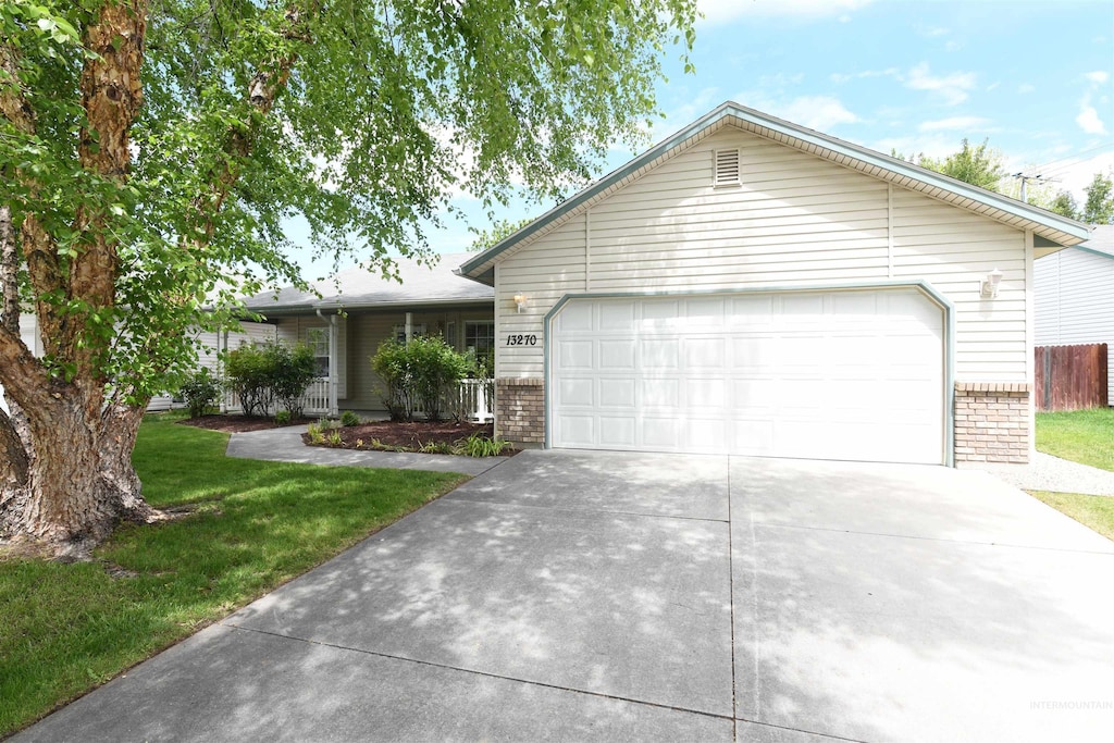 13270 W Satinleaf, Boise, ID 83713 - ranch-style house with driveway, brick siding, an attached garage, and a front lawn