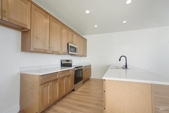 2950 Mcbride Pl, Burley, ID 83318 - kitchen with stainless steel appliances, an island with sink, sink, and light hardwood / wood-style floors