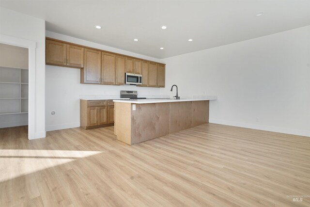2950 Mcbride Pl, Burley, ID 83318 - kitchen with a breakfast bar area, light hardwood / wood-style floors, and appliances with stainless steel finishes
