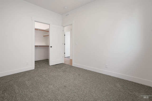 2950 Mcbride Pl, Burley, ID 83318 - unfurnished bedroom featuring dark colored carpet, a spacious closet, and a closet
