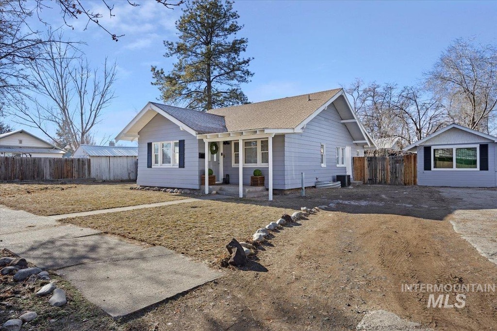 ranch-style house with a porch and an outbuilding