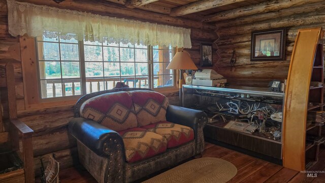 2742 Dixie Rd, Dixie, ID 83525 - living area featuring dark hardwood / wood-style floors, log walls, and beam ceiling