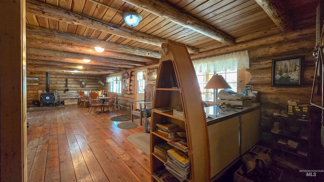2742 Dixie Rd, Dixie, ID 83525 - interior space featuring rustic walls, wood-type flooring, wooden ceiling, a wood stove, and beamed ceiling