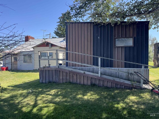 2131 N 2900 W, Arco, ID 83213 - rear view of property featuring a chimney, metal roof, and a lawn