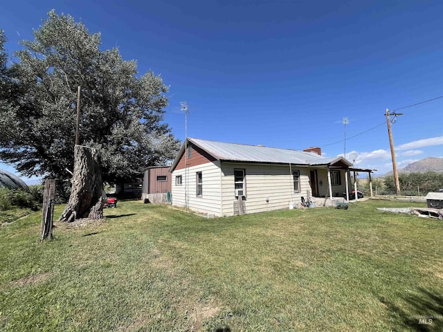 2131 N 2900 W, Arco, ID 83213 - view of side of property with metal roof and a lawn