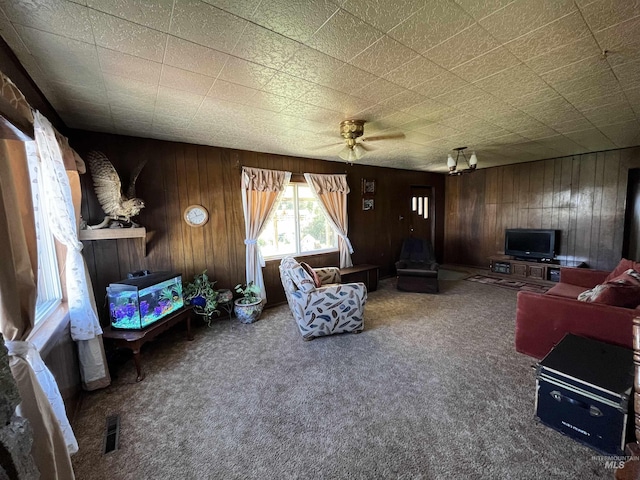 2131 N 2900 W, Arco, ID 83213 - carpeted living area featuring ceiling fan, wooden walls, and visible vents