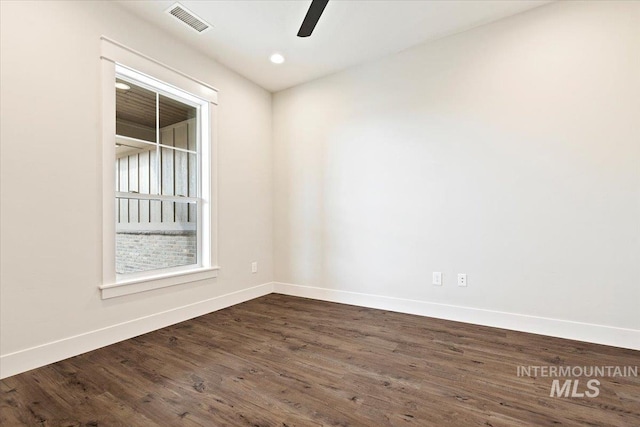 unfurnished room with ceiling fan and dark wood-type flooring