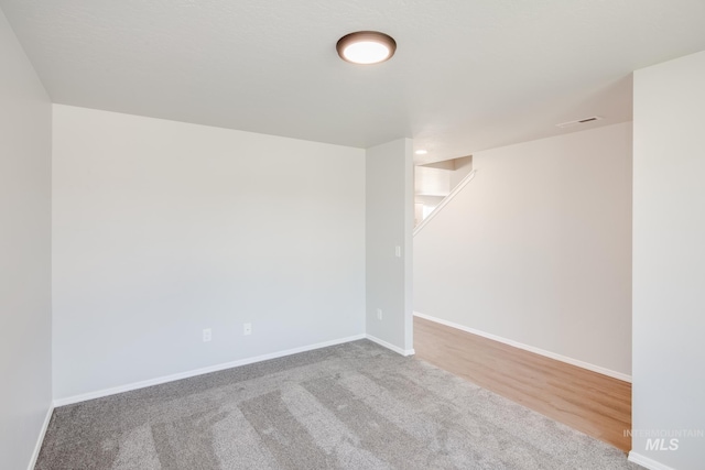 unfurnished room featuring light colored carpet