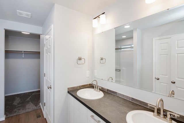 bathroom with hardwood / wood-style floors and vanity