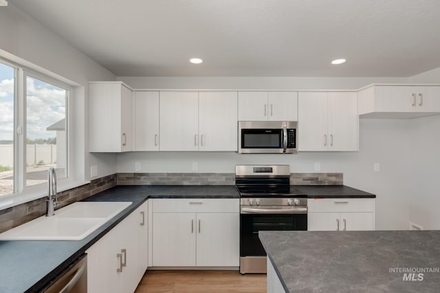 kitchen featuring white cabinets, a healthy amount of sunlight, and appliances with stainless steel finishes