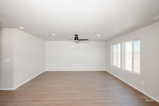 spare room featuring light wood-type flooring and ceiling fan