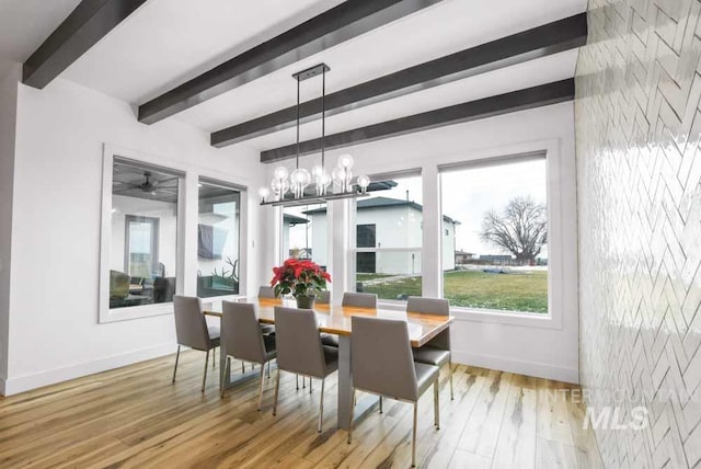 dining area featuring beamed ceiling, a chandelier, and hardwood / wood-style flooring