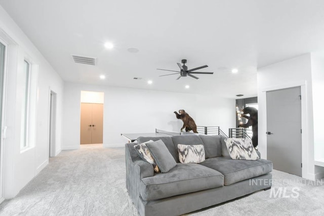 carpeted living room featuring ceiling fan