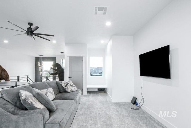 carpeted living room with ceiling fan