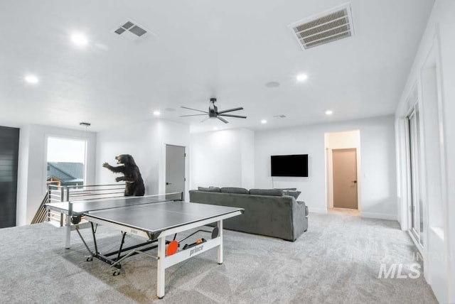 recreation room featuring light carpet and ceiling fan