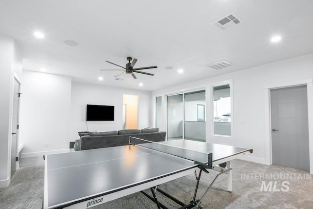 recreation room featuring ceiling fan and light colored carpet