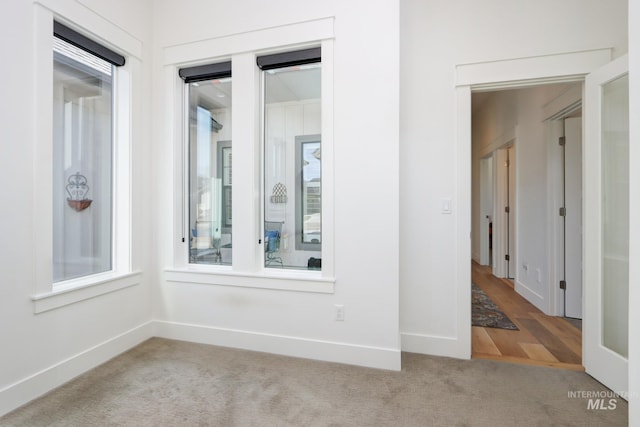 empty room featuring carpet flooring and baseboards