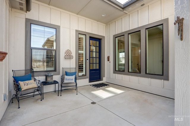 view of exterior entry featuring board and batten siding