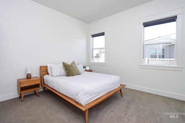 bedroom featuring baseboards and light carpet