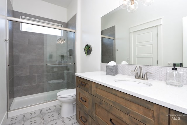 full bathroom with vanity, toilet, and a shower stall