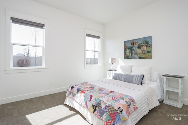 carpeted bedroom featuring baseboards