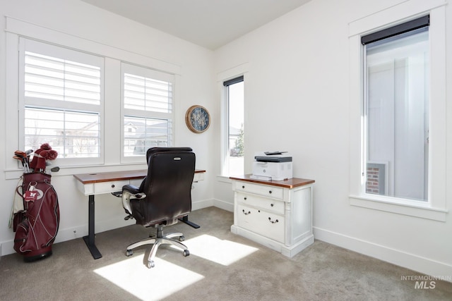 office space with baseboards and light carpet