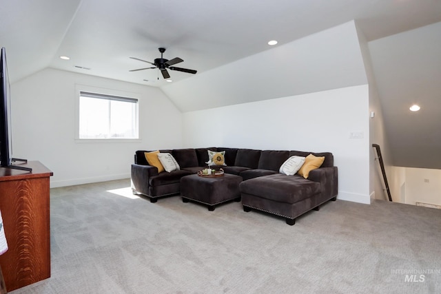 living area with vaulted ceiling, baseboards, and light carpet