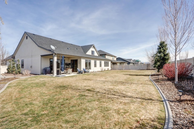 back of property featuring a yard, a patio, and fence