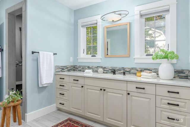 1919 N 21st St, Boise, ID 83702 - full bathroom with tasteful backsplash, baseboards, vanity, and a tile shower