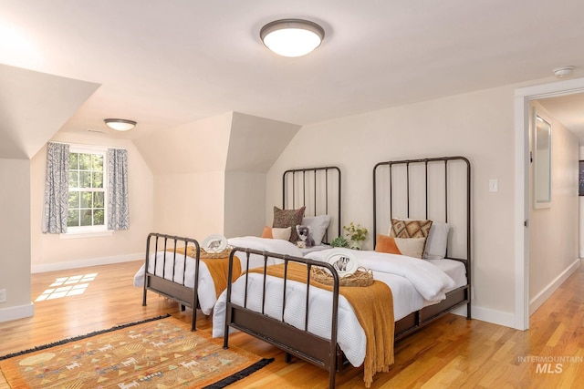 1919 N 21st St, Boise, ID 83702 - bedroom featuring light wood finished floors, baseboards, and vaulted ceiling