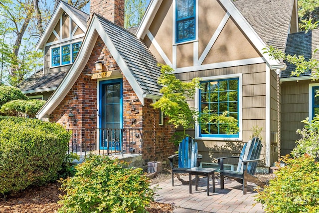 1919 N 21st St, Boise, ID 83702 - rear view of house with a chimney, brick siding, and a patio