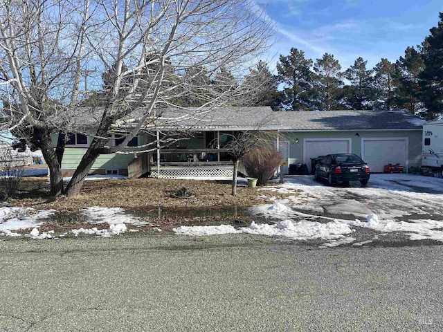 ranch-style house with a garage and driveway