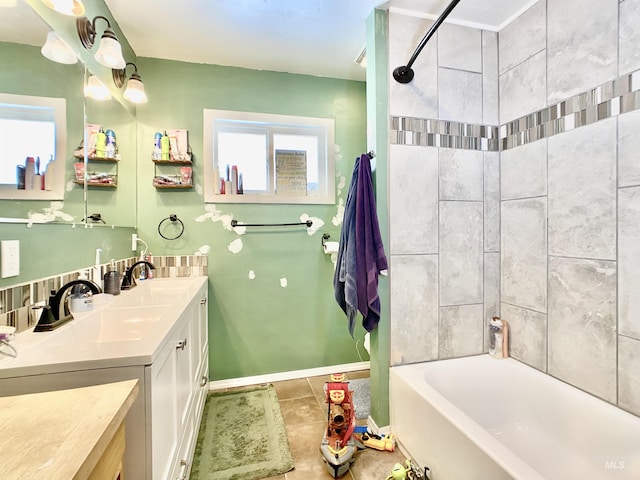 full bath featuring tile patterned flooring, tub / shower combination, vanity, and baseboards